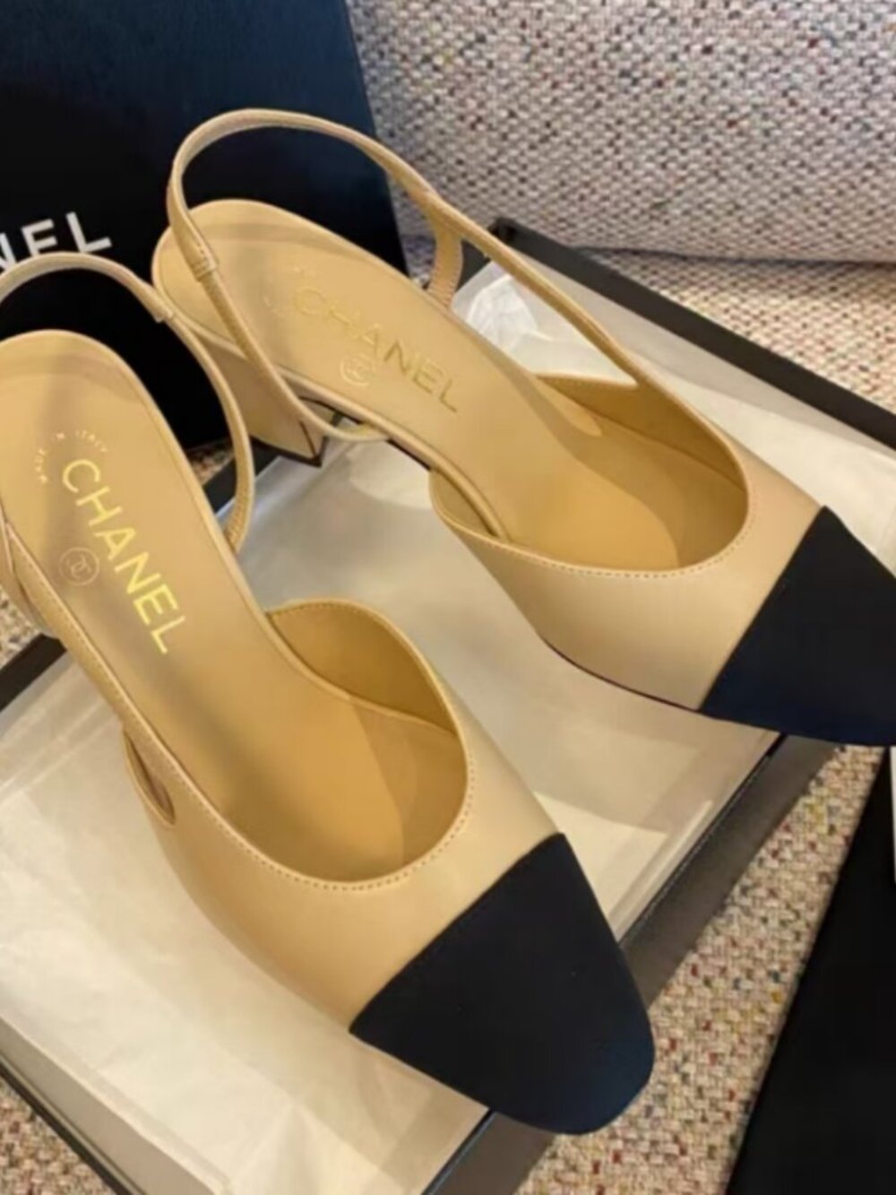 Beige and black cap-toe slingback block heels